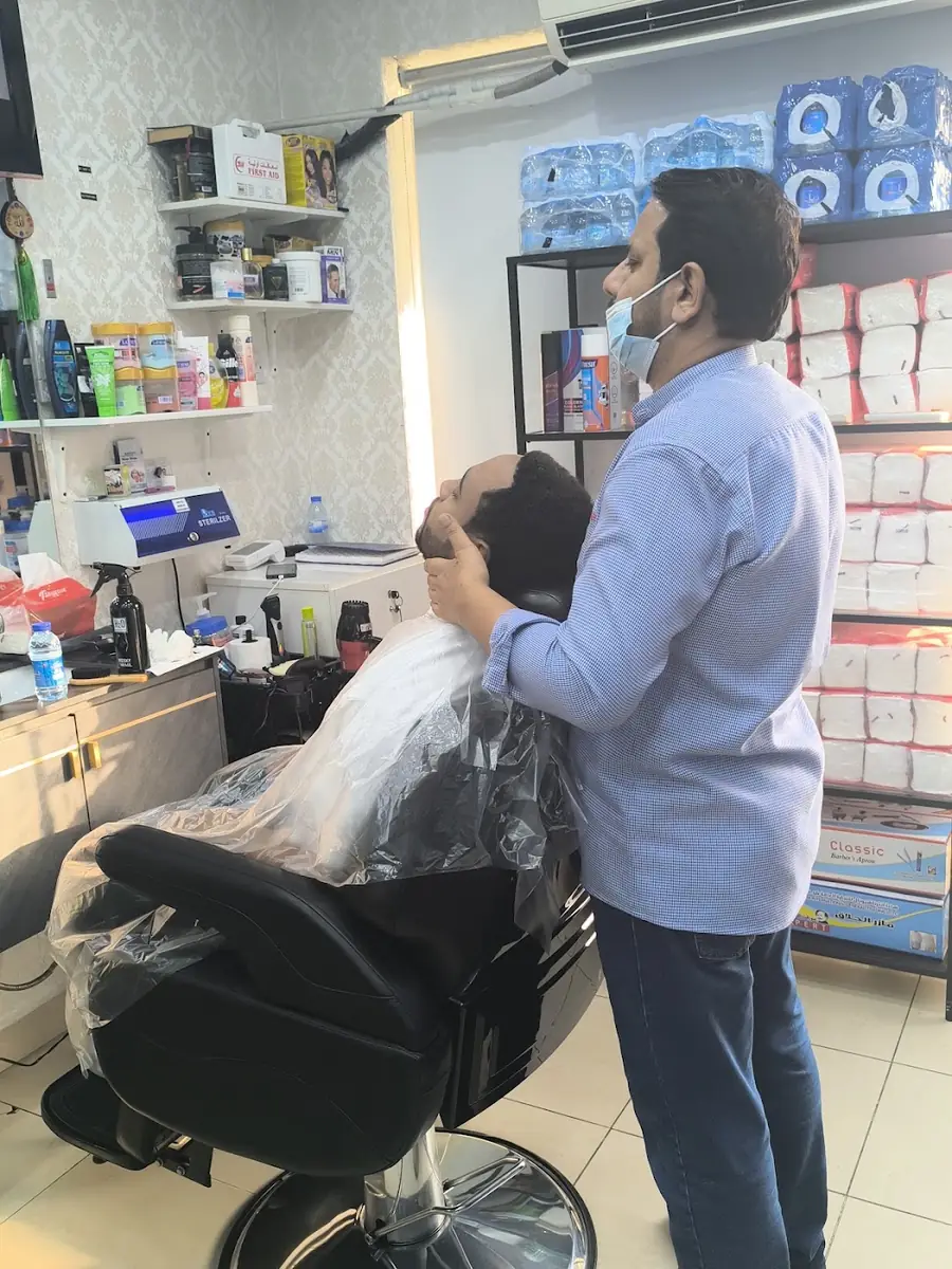 A barber at Decent Gents Salon working on a client's hair