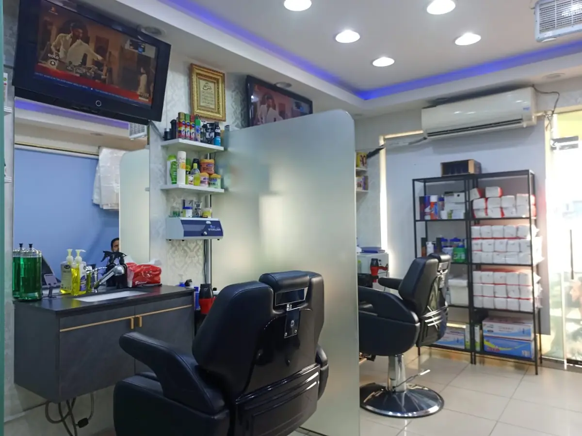 Row of barber chairs and mirrors inside Decent Gents Salon