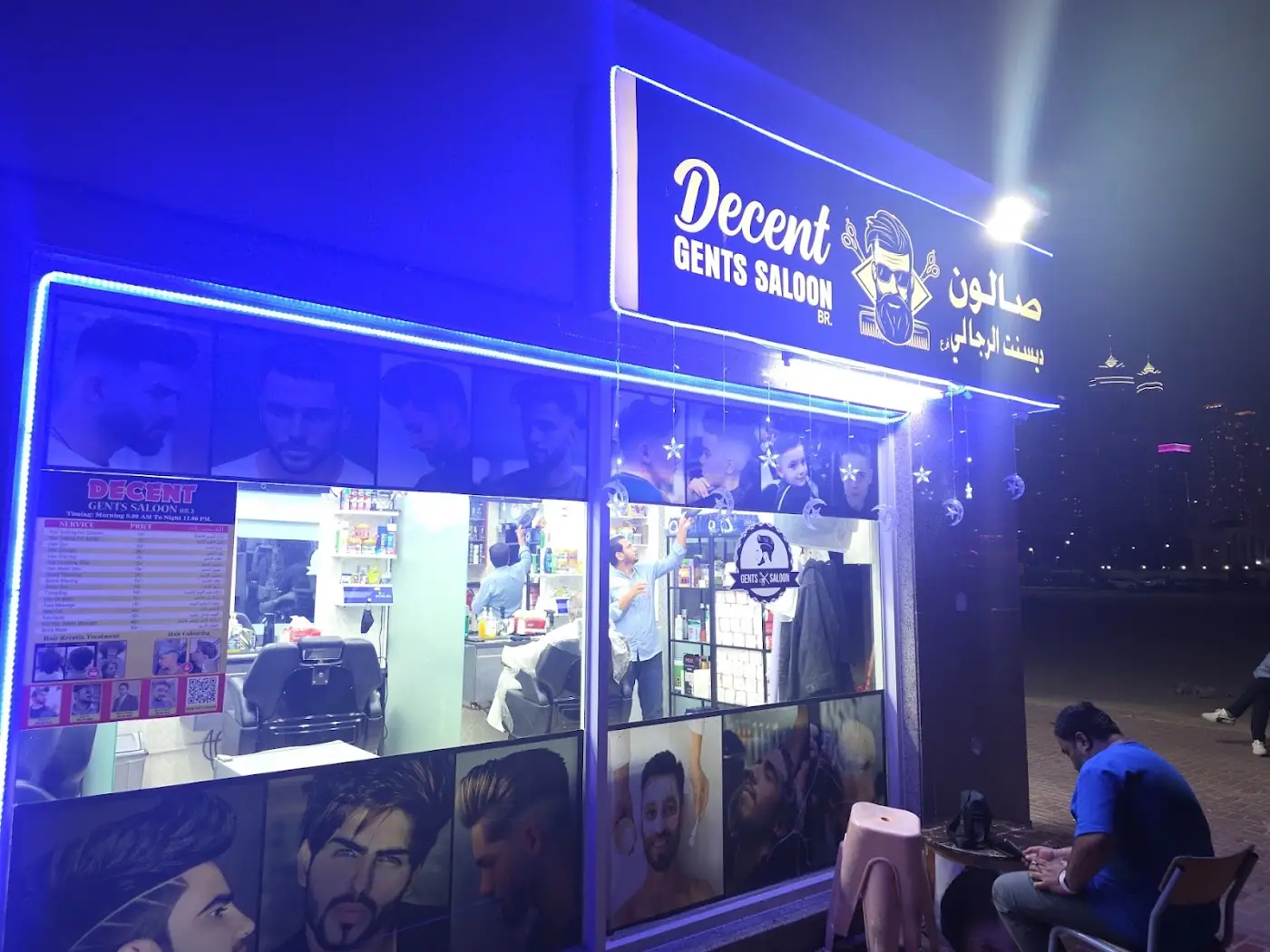Decent Gents Salon shopfront at night, its sign lit in blue